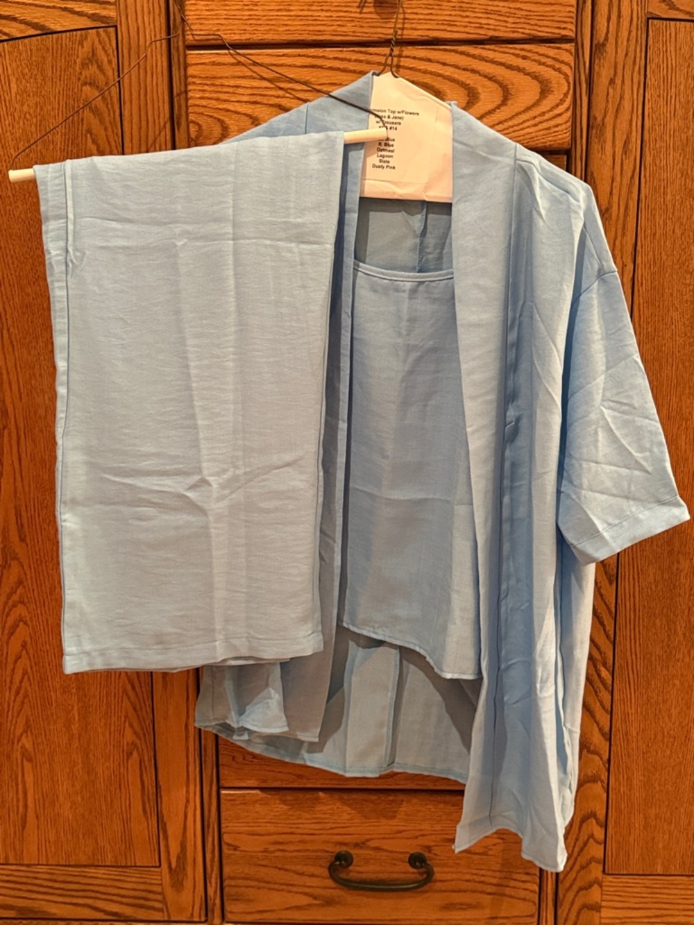 Light Blue Three-Piece Outfit: tank top, jacket, & trousers.